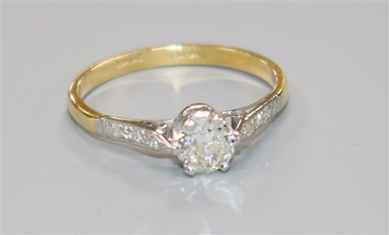 An 18ct gold and platinum set single stone diamond ring with diamond set shoulders, size 0.